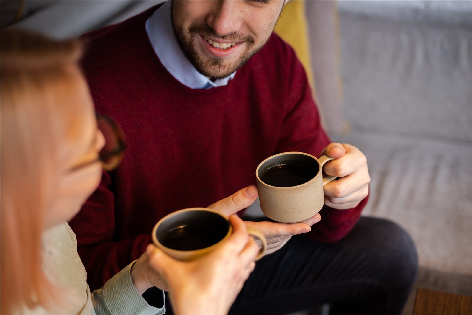 People sharing coffee and conversation at home