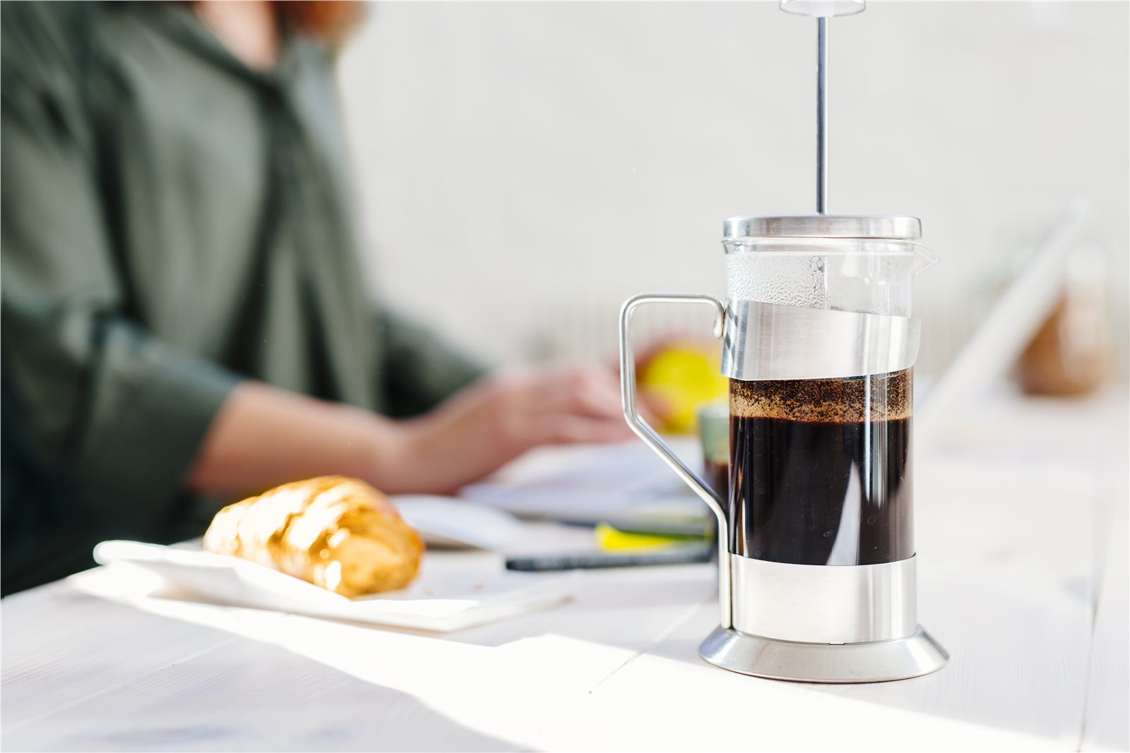 Coffee maker on a table during a work conversation